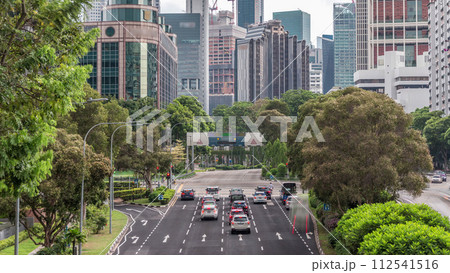 Traffic with cars on a street and urban scene in the central district of Singapore timelapse 112541516