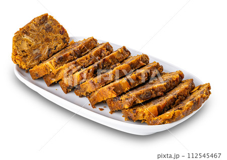 Sliced delicious fruitcake in white ceramic tray. Sliced delicious fruitcake in white ceramic tray. 112545467