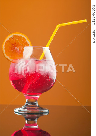 red coctail drink with ice cubs red coctail drink with ice cubs 112546653