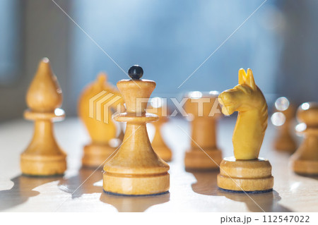 White chess pieces. The queen and her army. Bright saturated colors White chess pieces. The queen and her army. Bright saturated colors 112547022