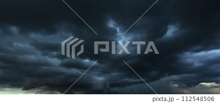 The dark sky with heavy clouds converging and a violent storm before the rain.Bad or moody weather sky and environment. carbon dioxide emissions, greenhouse effect, global warming, climate change The dark sky with heavy clouds converging and a violent storm before the rain.Bad or moody weather sky and environment. carbon dioxide emissions, greenhouse effect, global warming, climate change 112548506