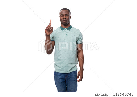 young smart american guy dressed in mint t-shirt holding thumbs up young smart american guy dressed in mint t-shirt holding thumbs up 112549746