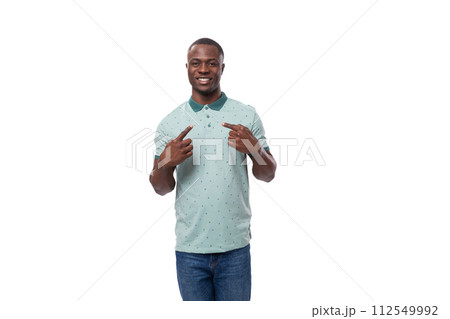 young smart american guy dressed in a mint t-shirt tells the news and points his finger young smart american guy dressed in a mint t-shirt tells the news and points his finger 112549992