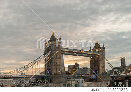 View of famous Tower bridge and skyline with reflections in the river thames just after sunset. 112551233