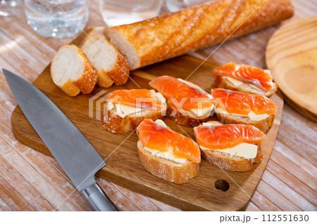 Appetizer canape of baguette with smoked salmon 112551630