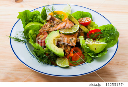 Salad with grilled trout, avocado, tomatoes, lettuce, lemon Salad with grilled trout, avocado, tomatoes, lettuce, lemon 112551774