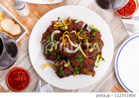 Pork shashlik with onion, greenery and glasses of wine Pork shashlik with onion, greenery and glasses of wine 112551908