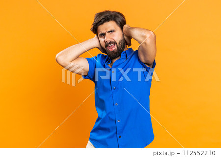 Annoyed irritated young man covering ears gesturing No avoiding advice ignoring noise loud voices Annoyed irritated young man covering ears gesturing No avoiding advice ignoring noise loud voices 112552210