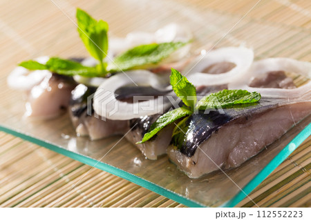 Marinated herring with sliced onion Marinated herring with sliced onion 112552223