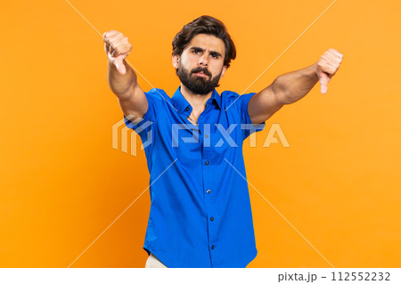 Upset attractive young man guy showing thumbs down sign gesture, disapproval dissatisfied dislike Upset attractive young man guy showing thumbs down sign gesture, disapproval dissatisfied dislike 112552232