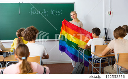 Teacher explaining LGBT flag meaning for kids during lesson Teacher explaining LGBT flag meaning for kids during lesson 112552256