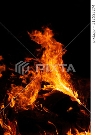 Close up of a bonfire blazing with intense heat against a 112553274