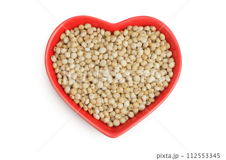 Sorghum seeds in ceramic bowl isolated on white background. Top view. Flat lay. 112553345