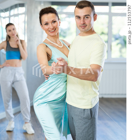 Female dance teacher performing waltz with male student Female dance teacher performing waltz with male student 112553797