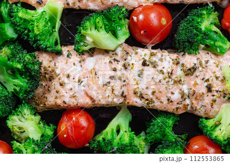 Baked salmon fillet with broccoli and tomato, one pan dish, horizontal, top view closeup Baked salmon fillet with broccoli and tomato, one pan dish, horizontal, top view closeup 112553865