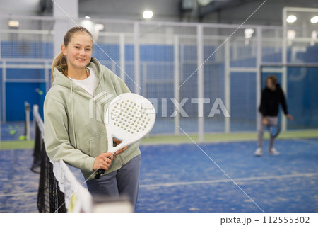 Young girl with racquet in padel court Young girl with racquet in padel court 112555302