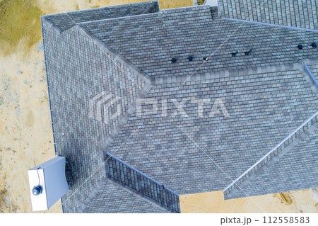 Asphalt shingles roof top newly constructed house 112558583