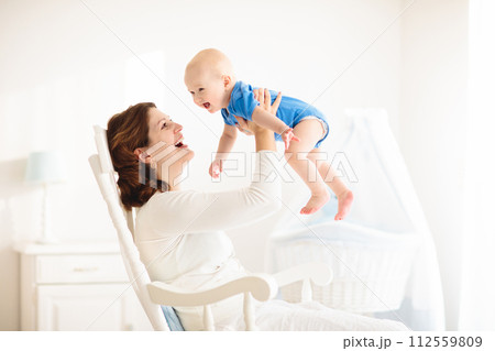 Happy young mother with baby boy at home 112559809