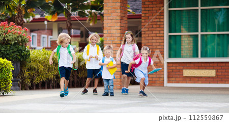 Child going back to school. Start of new school year after summer vacation. Little girl with backpack and books on first school day. Beginning of class. Education for kindergarten and preschool kids. 112559867