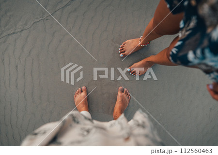 Summer travel concept feet on beach sand 112560463