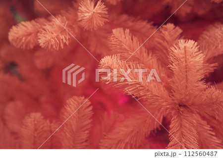 Side view of pink Christmas tree, background with copy space. Tree branches with selective focus, bokeh. Concept of textured background, greeting cards, congratulation, decor, wallpaper. 112560487