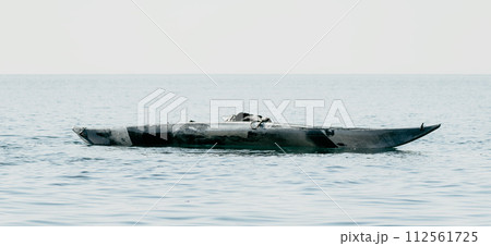 Woman sea kayak. Happy smiling woman in kayak on ocean, paddling with wooden oar. Calm sea water and horizon in background. Active lifestyle at sea. Summer vacation. Woman sea kayak. Happy smiling woman in kayak on ocean, paddling with wooden oar. Calm sea water and horizon in background. Active lifestyle at sea. Summer vacation. 112561725