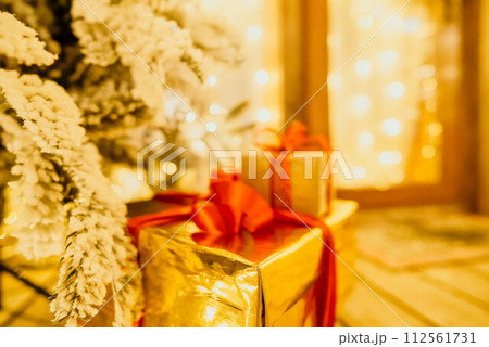 presents under Christmas tree, festive and celebratory atmosphere. 112561731