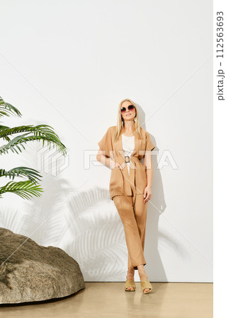 Portrait of relaxed woman in beige top and trousers 112563693