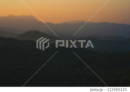 nature traveling with orange sky and layer of mountain with sunrise background nature traveling with orange sky and layer of mountain with sunrise background 112565233