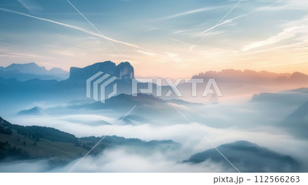 Panoramic view of the mountains in the fog at sunrise. 112566263