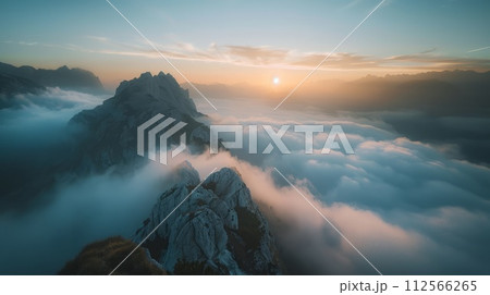 Aerial view of mountain peak in clouds at sunrise. Panorama 112566265