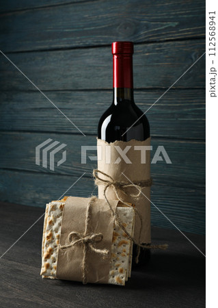Matzo and bottle of wine on wooden background 112568941