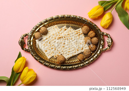 Matzo, nuts and flowers on pink background, top view Matzo, nuts and flowers on pink background, top view 112568949