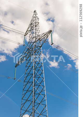 A power line mast against the sky and clouds. View from below A power line mast against the sky and clouds. View from below 112569298