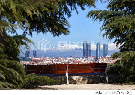 Sierra de Guadarrama. Mountain system seen from the city of Madrid with the recently snow-covered mountains covering the entire top of the mountain range in a white blanket. Skyline next to mountains. 112572180
