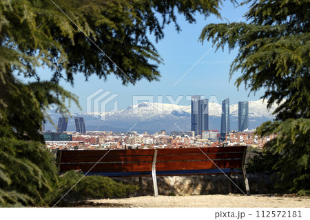 Sierra de Guadarrama. Mountain system seen from the city of Madrid with the recently snow-covered mountains covering the entire top of the mountain range in a white blanket. Skyline next to mountains. 112572181
