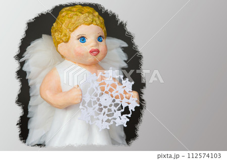 Doll angel with a knitted snowflake close-up 112574103
