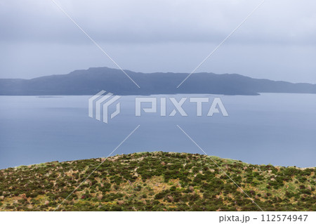 A serene expanse of sea merges with the hazy Raasay Island under a soft grey sky, Isle of Skye A serene expanse of sea merges with the hazy Raasay Island under a soft grey sky, Isle of Skye 112574947