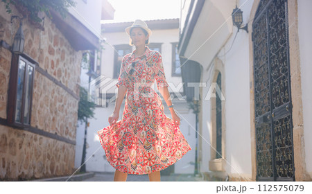 female summer travel to Antalya, Turkey. young asian woman in red dress walk through old town Kalechi , female tourist traveler discover interesting places and popular tourist attraction female summer travel to Antalya, Turkey. young asian woman in red dress walk through old town Kalechi , female tourist traveler discover interesting places and popular tourist attraction 112575079