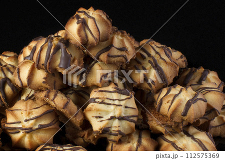 Shortbread cookie with chocolate icing on a dark background Shortbread cookie with chocolate icing on a dark background 112575369