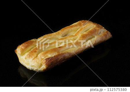 Bun with puff pastry with cottage cheese on a dark background 112575380