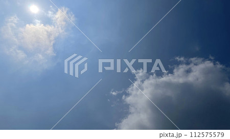 Heavenly white clouds on the blue sky with the sun appeared Heavenly white clouds on the blue sky with the sun appeared 112575579