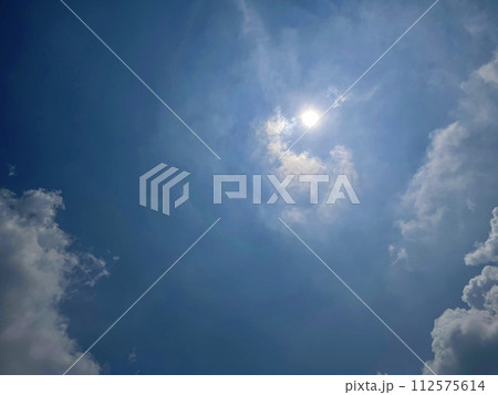Heavenly white clouds on the blue sky with the sun appeared 112575614