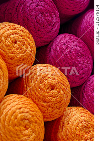 Balls of orange and red threads 112576154