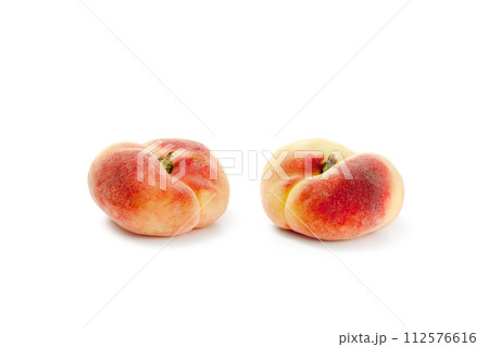 Two saturn peaches or flat peaches isolated on white background with clipping path.. 112576616