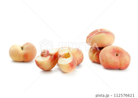 Half and several whole saturn peaches or flat peaches isolated on white background with clipping path.. Half and several whole saturn peaches or flat peaches isolated on white background with clipping path.. 112576621