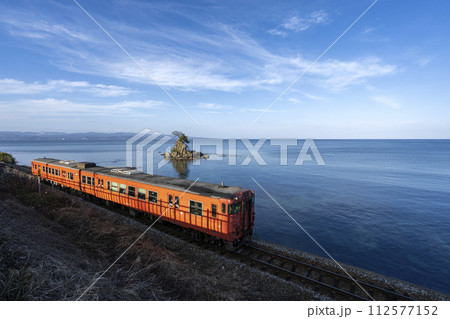 雨晴海岸沿いを走る氷見線の列車 112577152