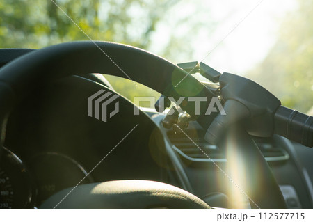 Robot arm on a steering wheel. Artificial intelligence drives a car. Autonomous vehicle concept. Robot arm on a steering wheel. Artificial intelligence drives a car. Autonomous vehicle concept. 112577715