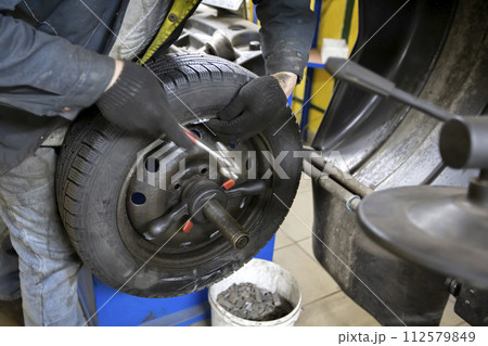 Car wheel repair in a tire workshop. Car wheel repair in a tire workshop. 112579849
