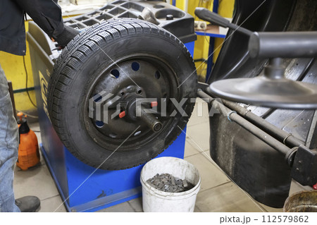 Car wheel repair in a tire workshop. 112579862